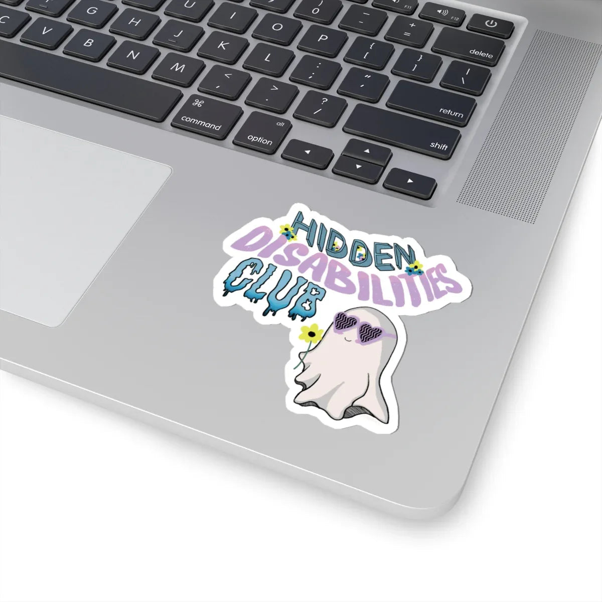 Durable, long-lasting sticker on a skateboard with text "Hidden Disabilities Club" in colorful pastel, playful font, and a smiling ghost wearing sunglasses, holding a yellow flower. Fun and inclusive tone.