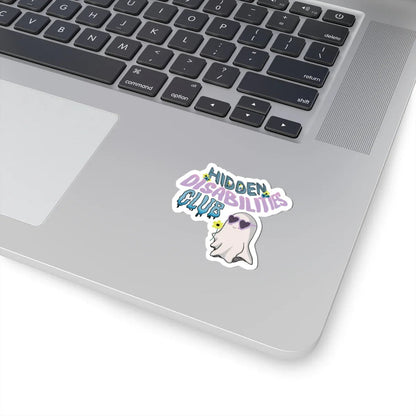 Durable, long-lasting sticker on a skateboard with text "Hidden Disabilities Club" in colorful pastel, playful font, and a smiling ghost wearing sunglasses, holding a yellow flower. Fun and inclusive tone.