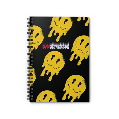 Black spiral notebook with yellow melting smiley faces repeating pattern. Text reads "overstimulated" in red and white. Edgy and playful design.