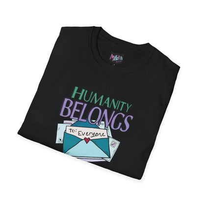 Folded black T-shirt with "Humanity Belongs" in colorful letters above an envelope labeled "to: Everyone" with a heart seal, conveying inclusivity.
