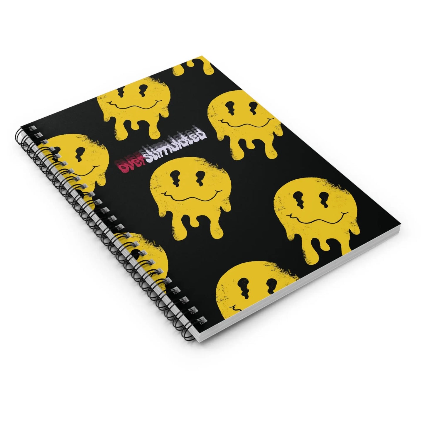 Spiral-bound notebook with black cover, featuring repeated yellow, drippy smiley faces and the word "Overstimulated" in glitchy white and red text.