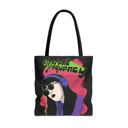 Illustrated black tote bag with a stylish person wearing headphones and sunglasses on a pink background. Text reads "different frequency." Retro vibe.