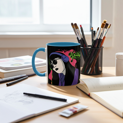 A sleek, edgy microwave and dishwasher-safe glossy blue mug with a graphic of a girl wearing headphones and sunglasses, set on a wooden surface surrounded by art supplies.