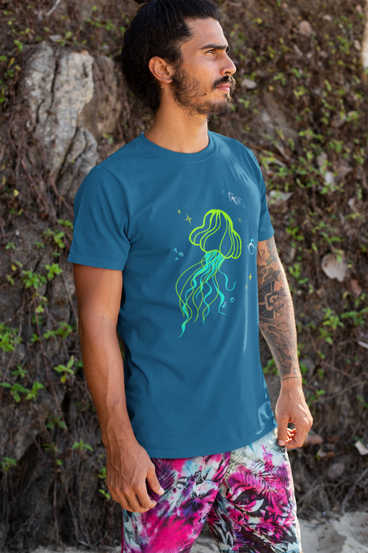 Man wearing a blue t-shirt with a neon jellyfish minimalist design, standing against a natural background.