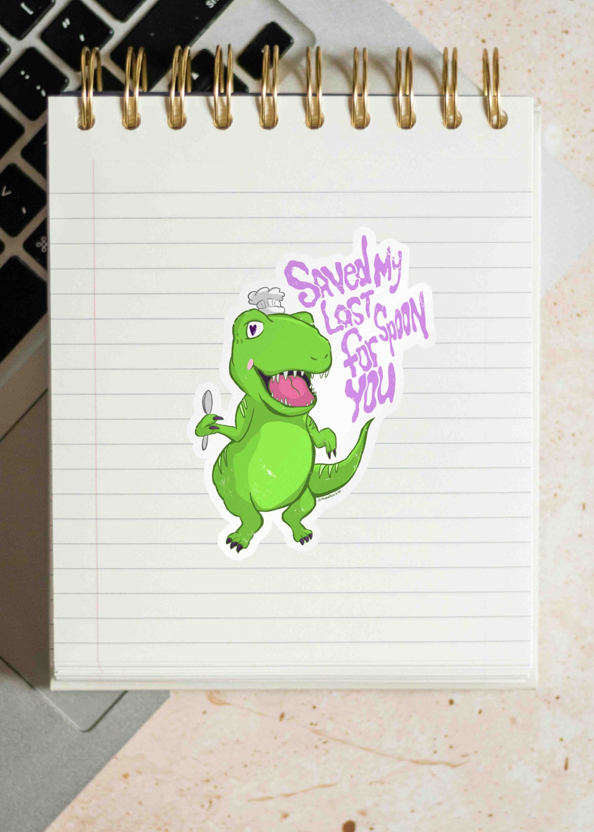 A Saved My Last Spoon For You dino sticker on a notebook page. 