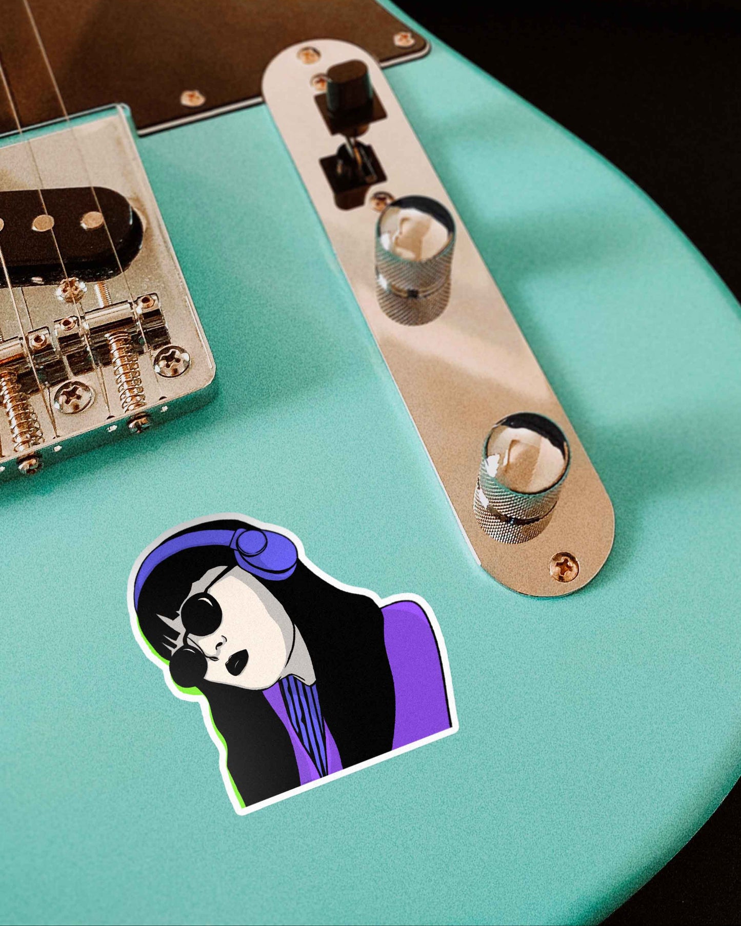 Headphone Cyberpop Girl Hand-Drawn Sticker on turquoise electric guitar in a close-up. Creating a cool, vibrant vibe.